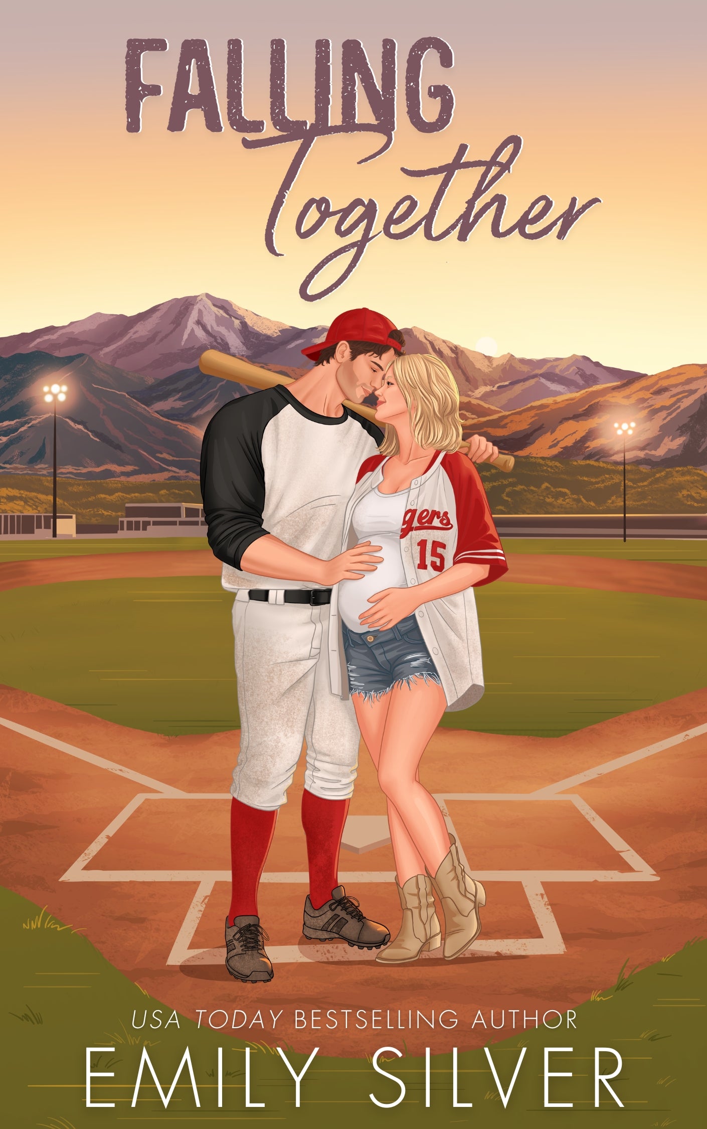 Book cover of 'Falling Together' featuring a couple on a baseball field with mountains in the background.